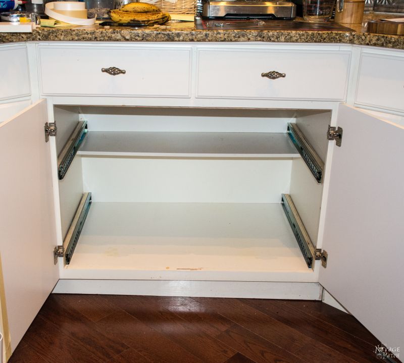 empty cabinet with new drawer slides installed for slide-out shelves