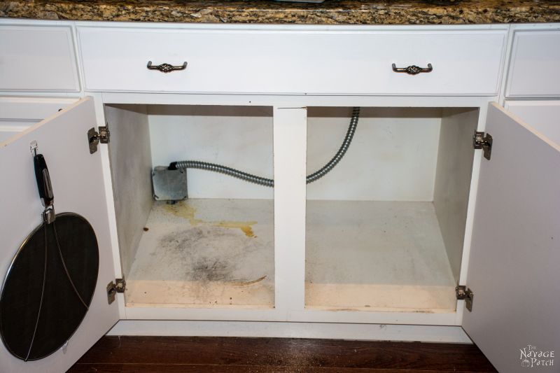 empty cabinet below stove