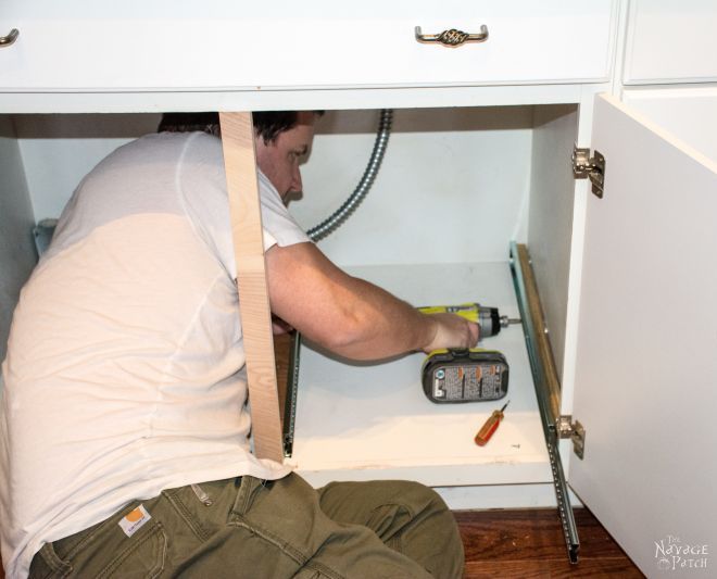 lumpy man squeezed into an empty cabinet