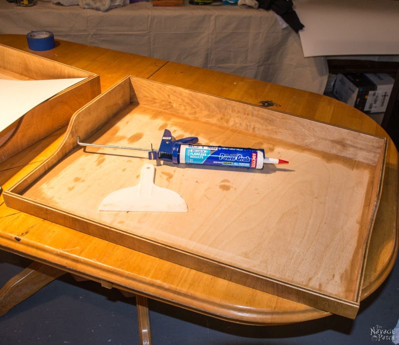 tube of construction adhesive on a diy slide out shelf