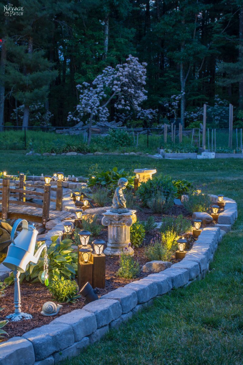 cedar cube solar landscape lights in a garden at dusk