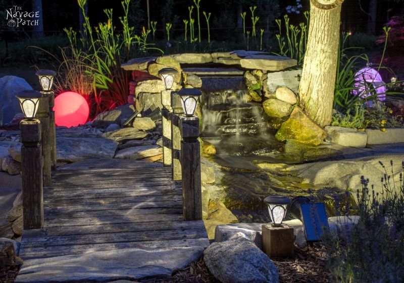 cedar cube solar landscape lights in a garden at night