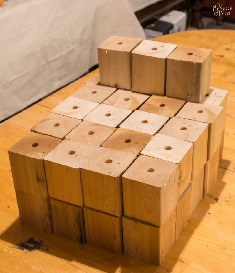 stack of cedar cubes with holes drilled their tops