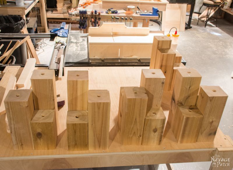 pieces of cedar 4 x 4 of varying height with holes in tops