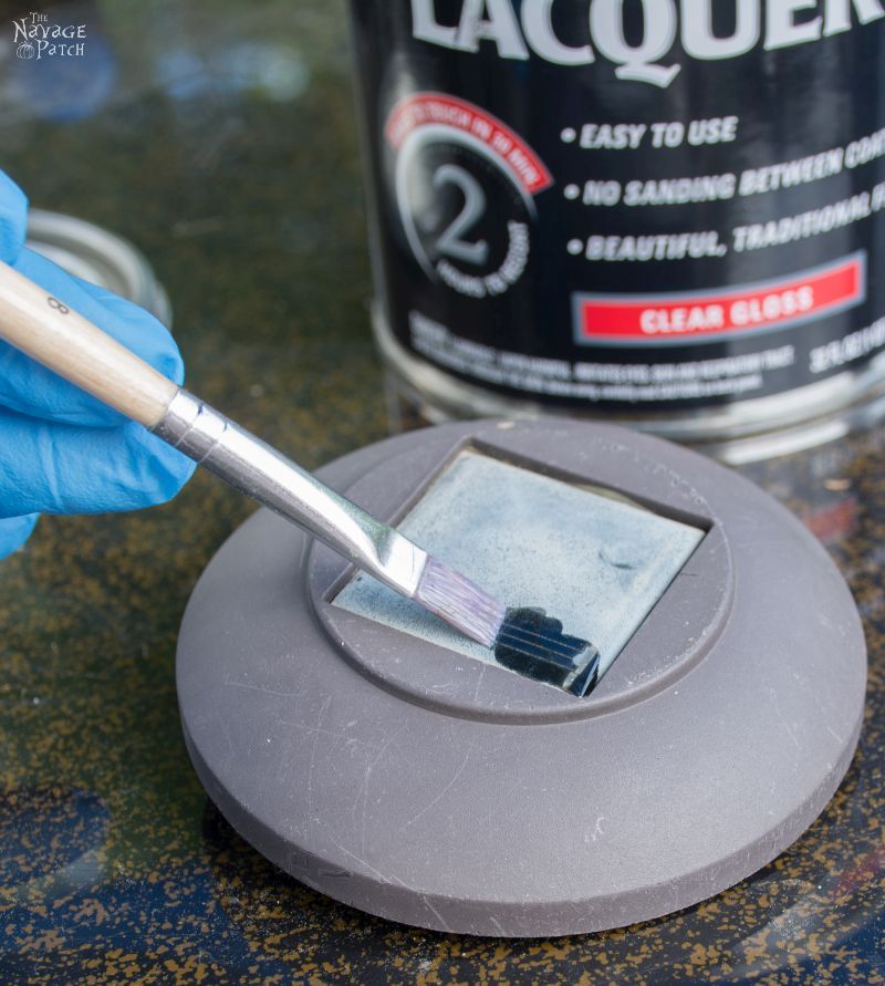 small brush applying lacquer to hazy solar panel