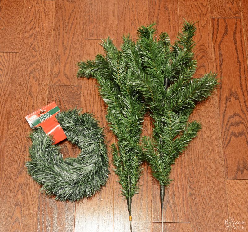 fake christmas tree branches on a floor