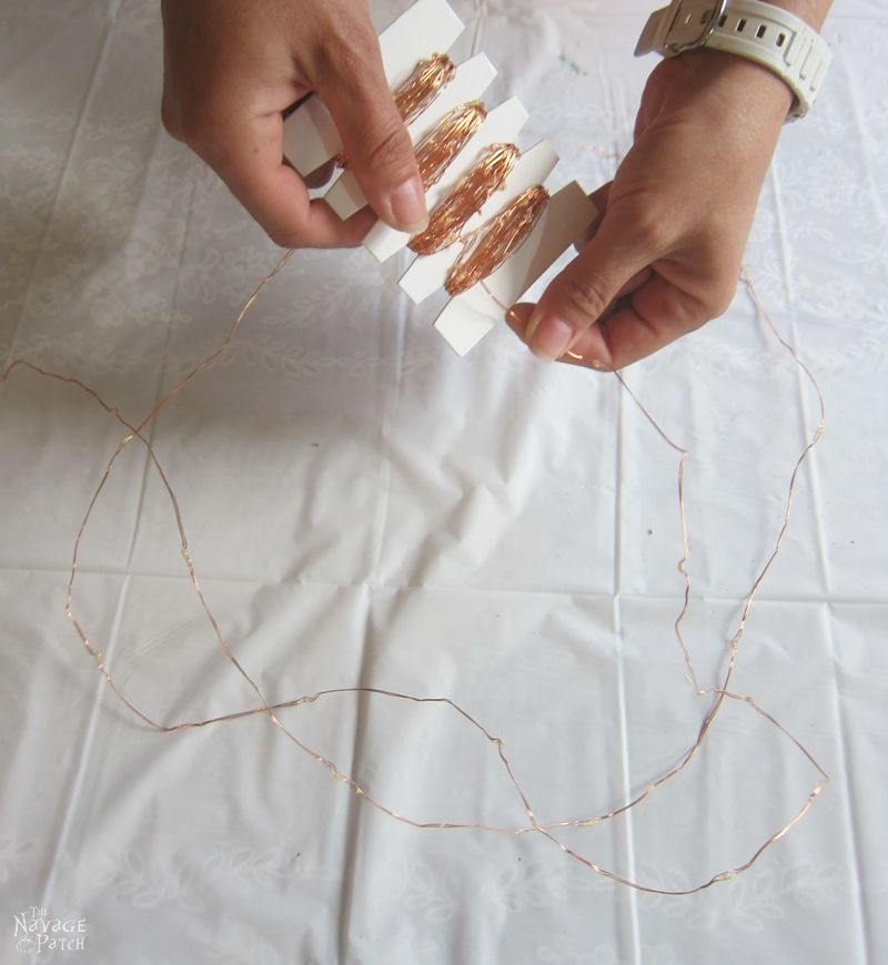 woman's hands unwrapping solar string lights