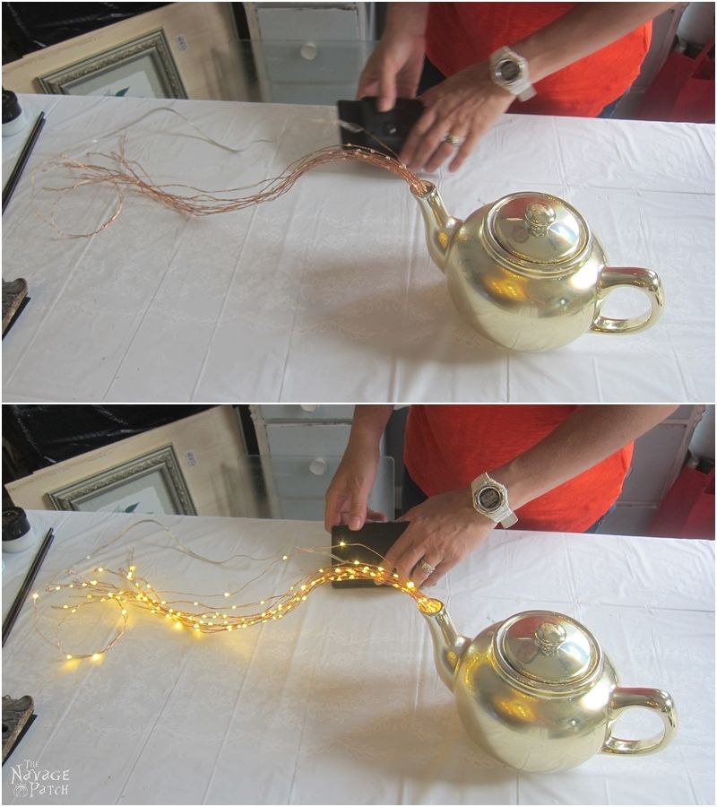 testing solar string lights before placing the teapot light in the garden