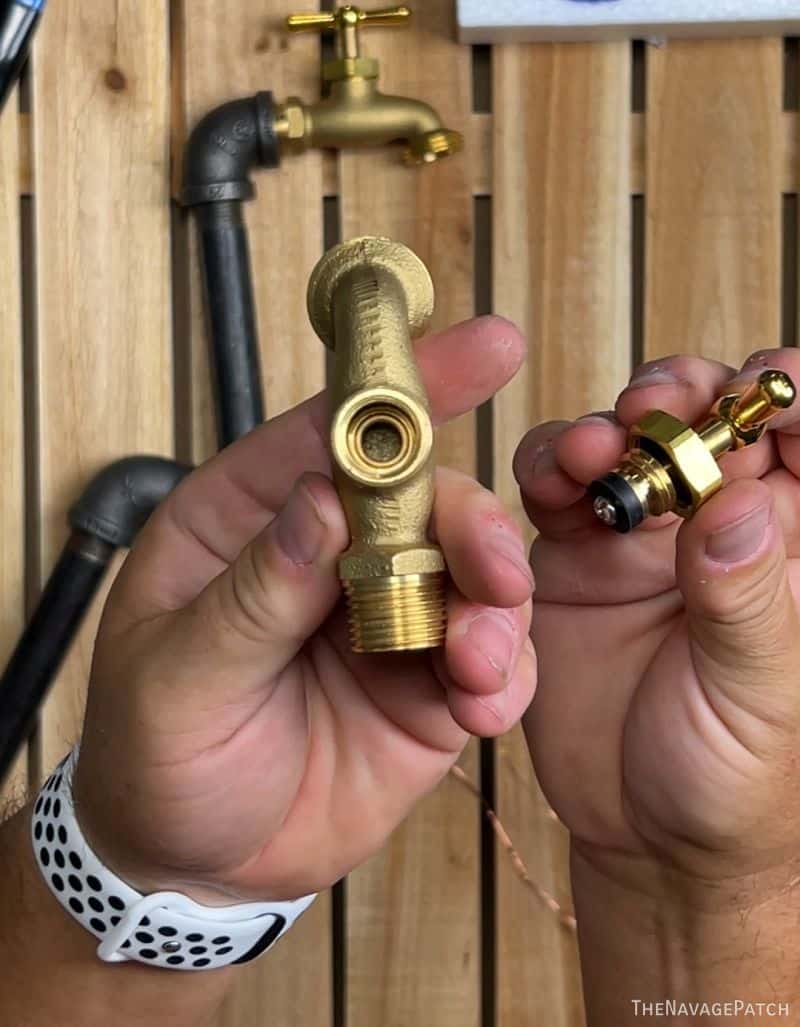 man holding brass spigot