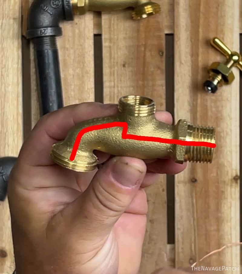 man holding brass spigot