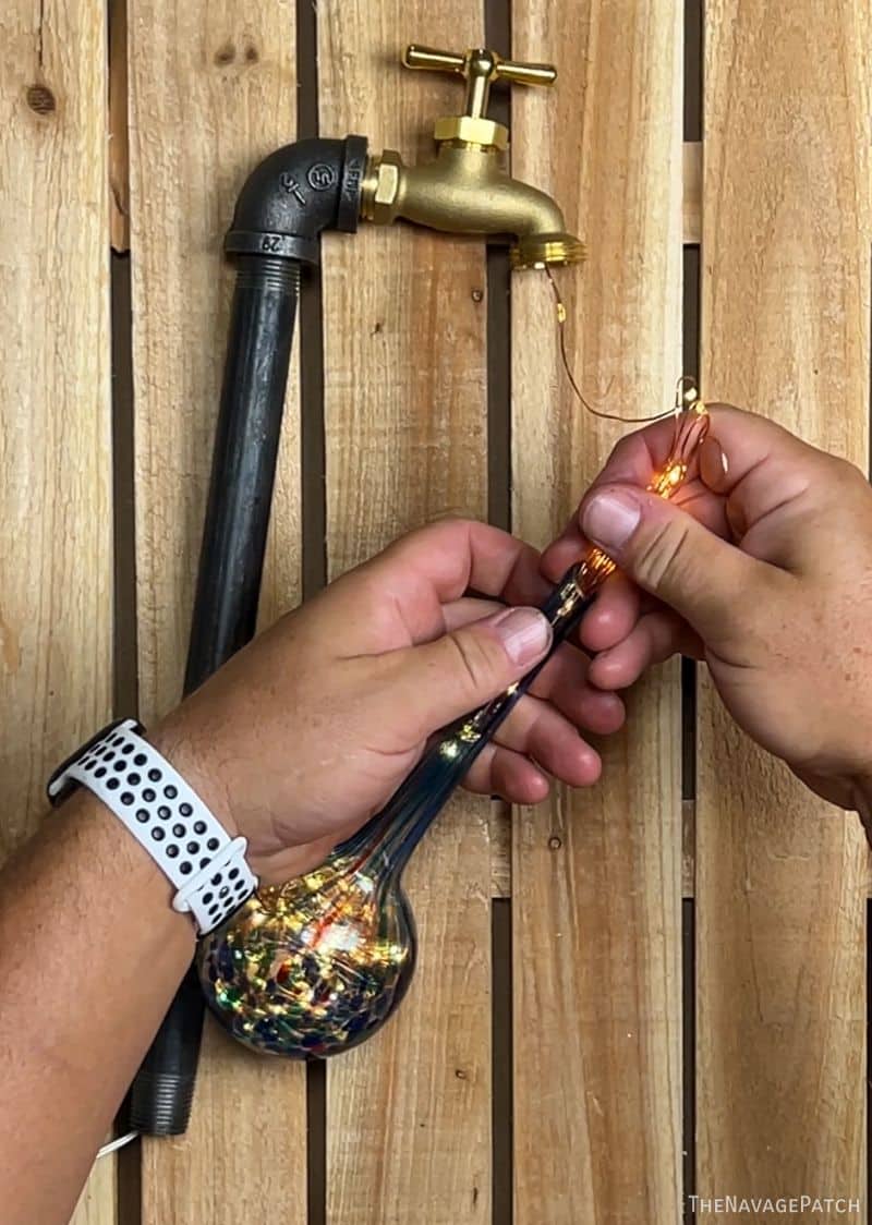 man making waterdrop solar lights