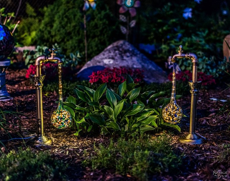 Side view of two DIY Solar Garden Lights in a garden at dusk