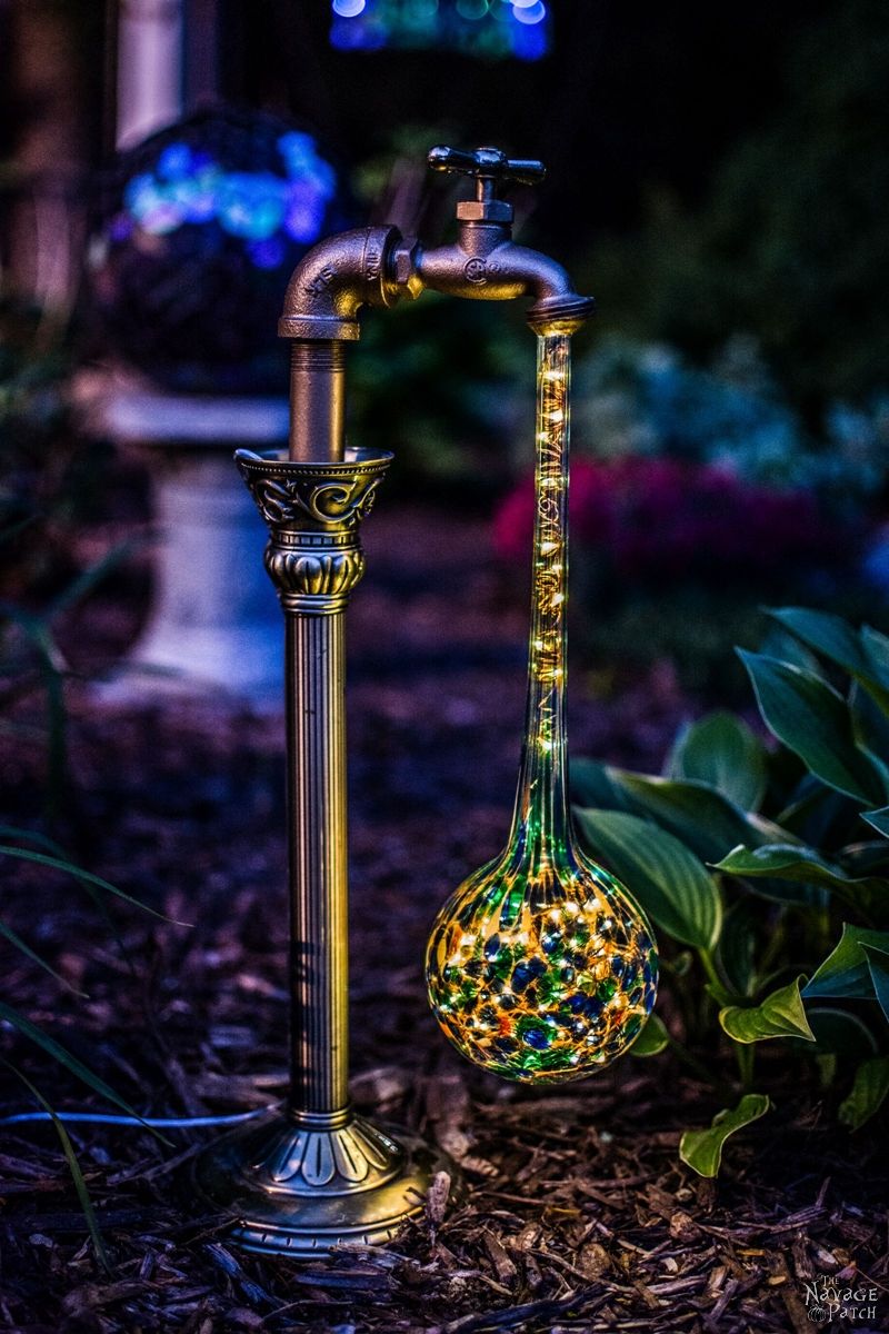 side view of one solar garden light in a garden at dusk