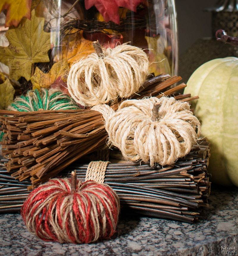 sisal twine pumpkins arranged on a hearth