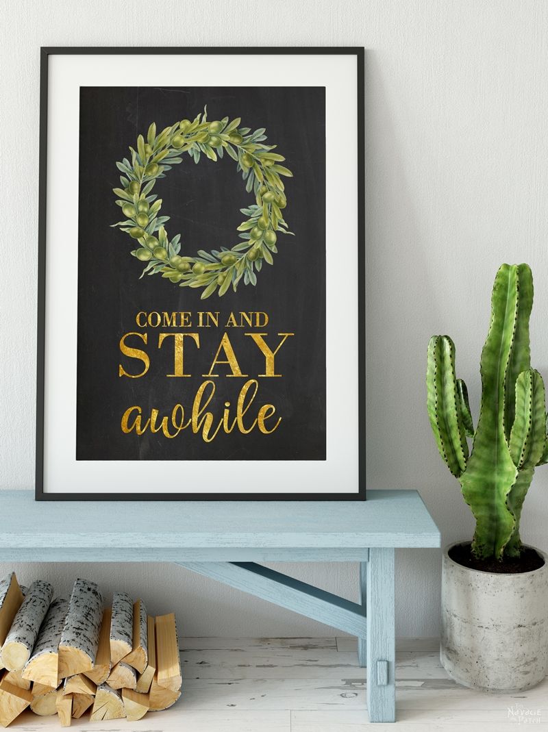 DIY Stay Awhile Sign with Free Printable | Free printable Stay Awhile sign and olive wreath | Free printable eucalyptus wreath and farmhouse style wall art | Gilded Stay Awhile sign | Ready to print DIY wall decoration | Upcycled frame | Stay Awhile sign with boxwood wreath | #TheNavagePatch #FreePrintable #GalleryWall #Upcycled #DIY #HomeDecor | TheNavagePatch.com