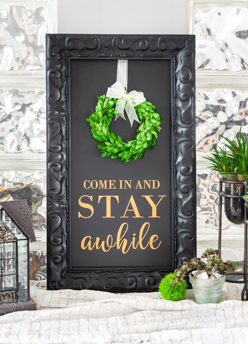 DIY Stay Awhile Sign with Free Printable | Free printable Stay Awhile sign and olive wreath | Free printable eucalyptus wreath and farmhouse style wall art | Gilded Stay Awhile sign | Ready to print DIY wall decoration | Upcycled frame | Stay Awhile sign with boxwood wreath | #TheNavagePatch #FreePrintable #GalleryWall #Upcycled #DIY #HomeDecor | TheNavagePatch.com