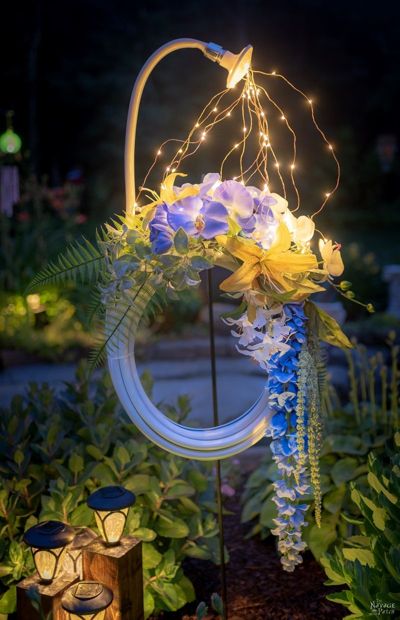 Lighted Garden Hose Wreath | DIY lighted summer wreath | Garden hose watering lights | Repurposed garden shed decor | Upcycled backyard decor | Summer wreath with fairy lights | #TheNavagePatch #GardenShed #garden #DIY #gardendecor #Upcycled #Repurposed #summerwreath #gardenart #diycrafts #Porchdecor #backyard #easydiy #outdoors #summerlife | TheNavagePatch.com