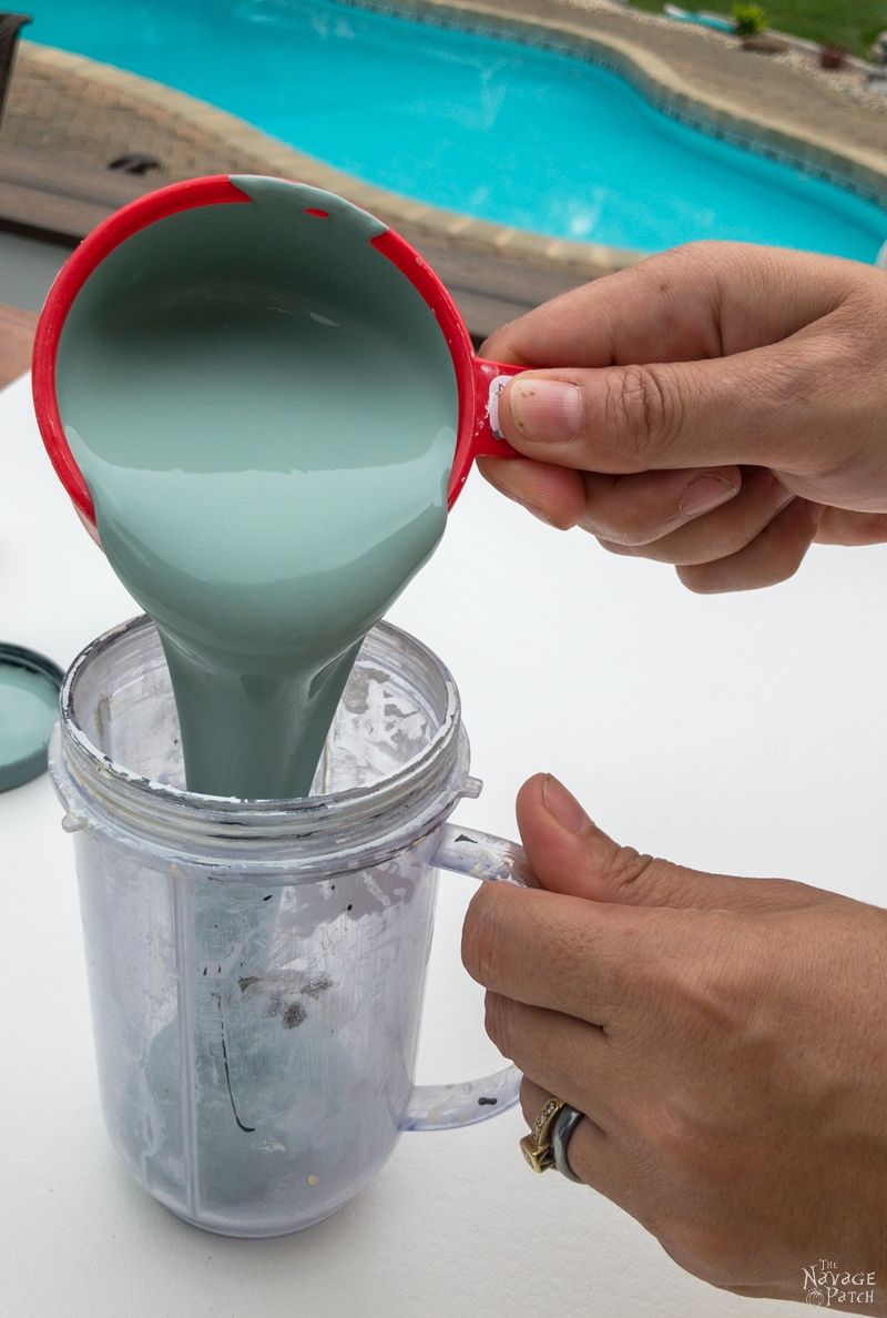 woman pouring green paint into a cup