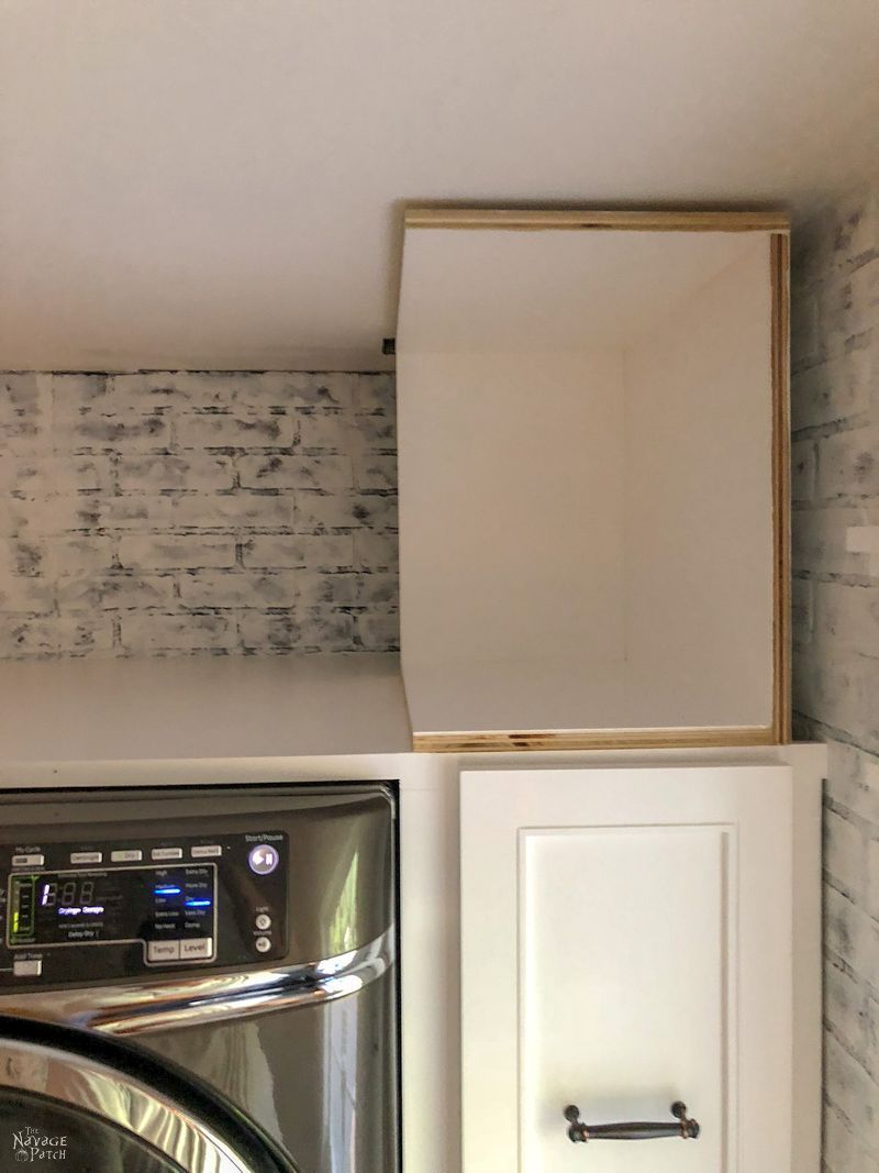 Laundry Room Cabinet with Pull-Out Shelves | DIY pull-out shelf | How to make sliding shelves for laundry room cabinet | DIY slide-out shelf and cabinet tutorial | DIY Laundry Room cabinet with Dog Feeding Station | How to install CabinetNow doors | Best paint for cabinets | #TheNavagePatch #diy #Laundry #organization #Cabinet #Tutorial #HowTo #Paintedfurniture #diyfurniture #dogfeedingstation | TheNavagePatch.com