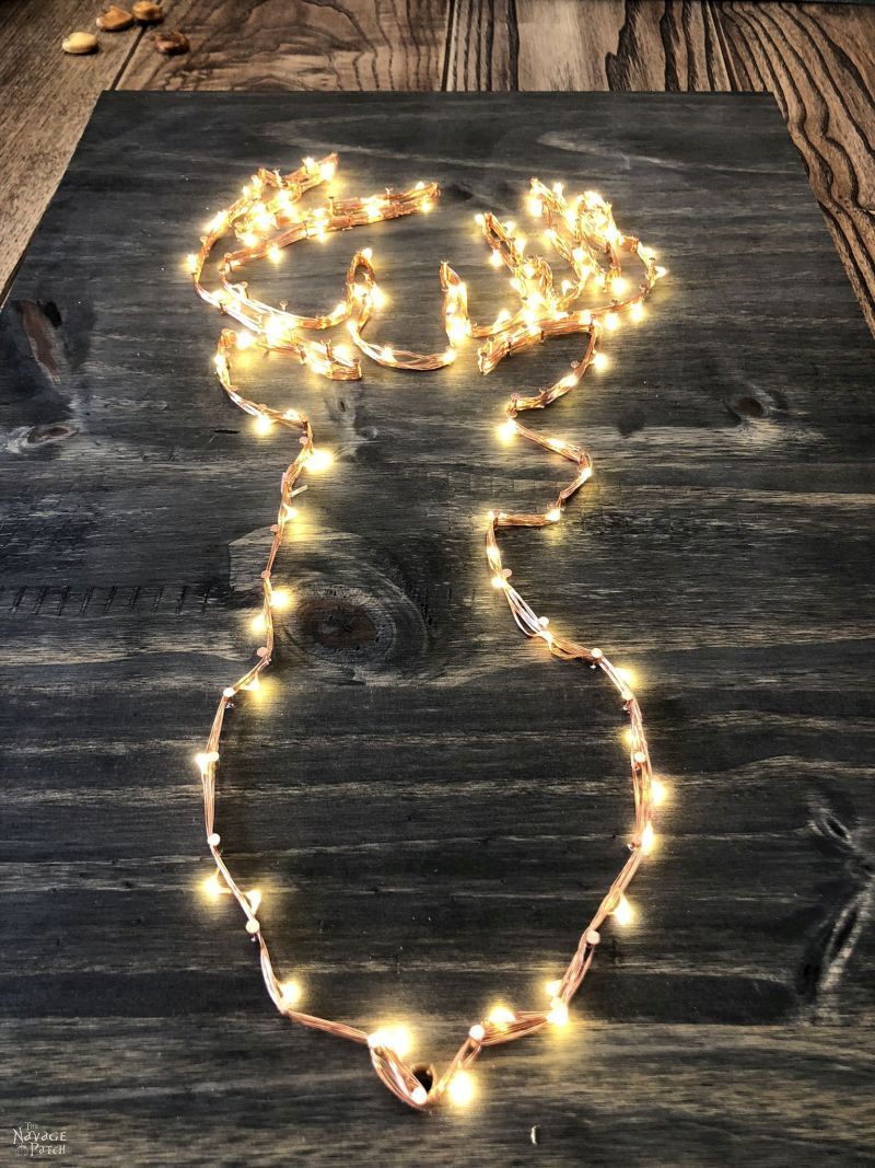 DIY Lighted Christmas Signs | DIY lighted reindeer decoration | DIY Christmas tree sign | Quick and easy DIY Christmas decoration with lights | Free printable reindeer template | #TheNavagePatch #DIY #freeprintable #Christmas #Holidaydecor #DIYChristmas #Christmascrafts #easydiy #Christmaslights #DIYHomedecor #Holidays #starrylights | TheNavagePatch.com