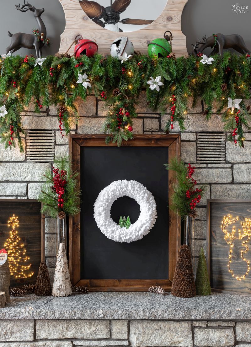 diy winter wreath set upon a fireplace hearth