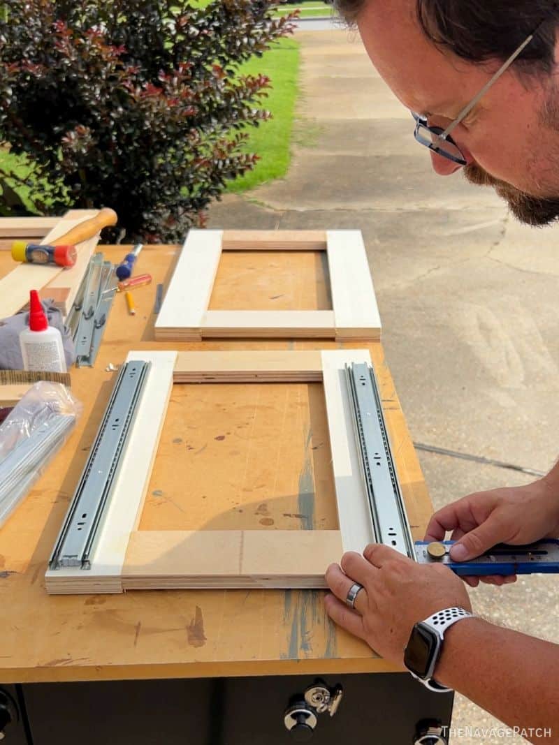 man installing drawer slides