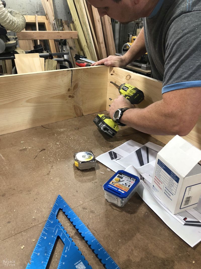 man screwing together daybed frame with pocket screws