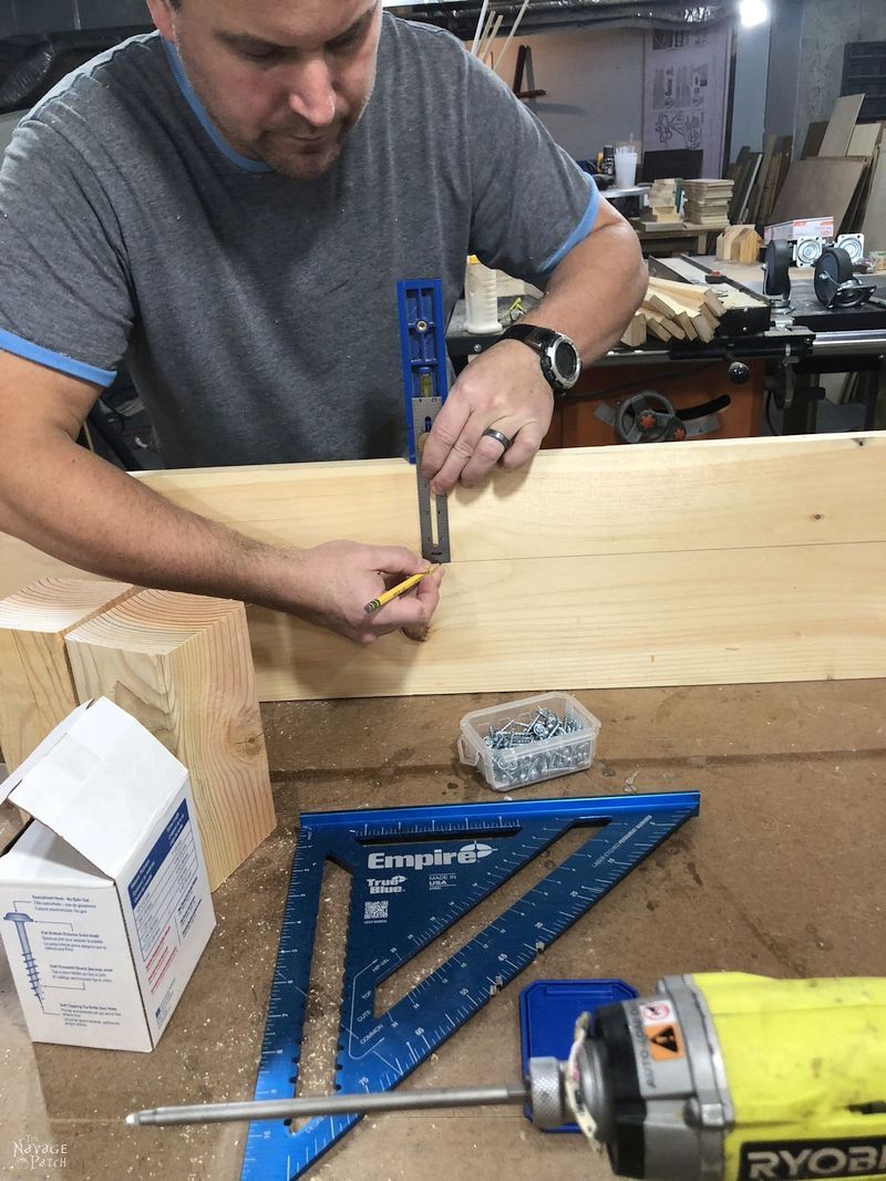 man tracing a line onto a board