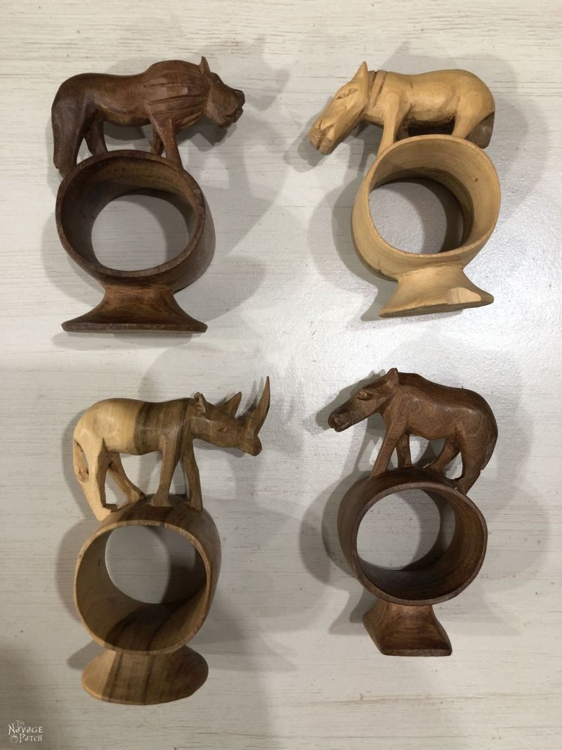 four wooden napkin rings with carved animals