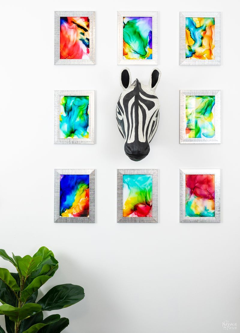 8 DIY Fired Alcohol Ink Art hanging on a white wall
