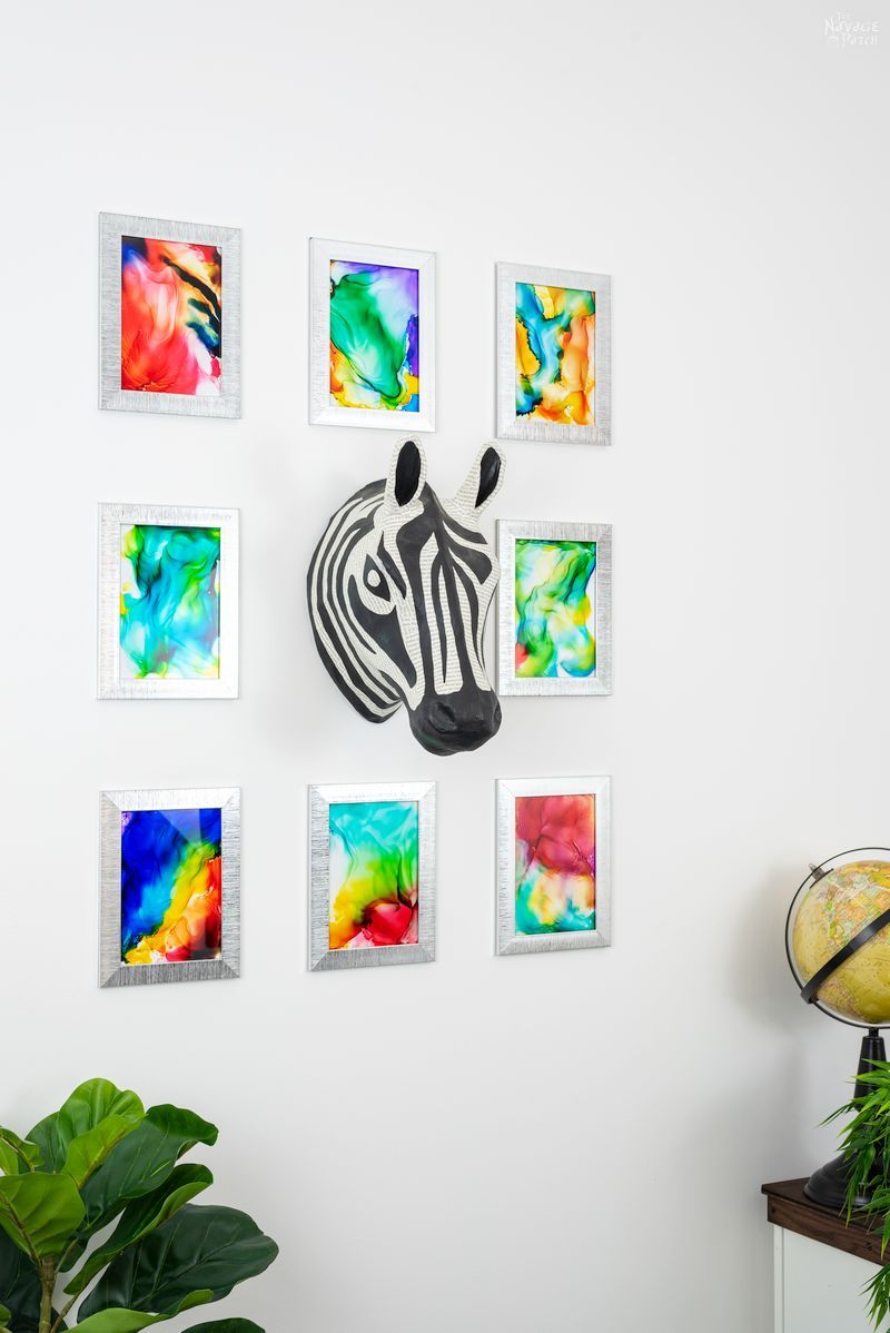 8 Fired Alcohol Ink Art hanging on a white wall 