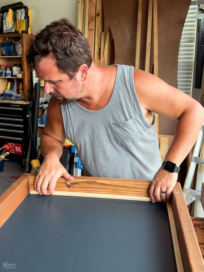 man working on a guitar display case