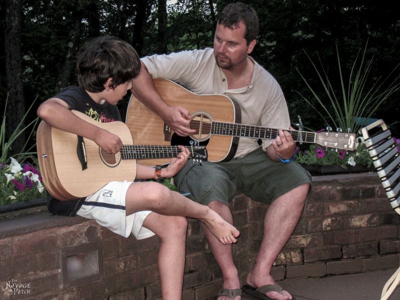 father and son playing guitar