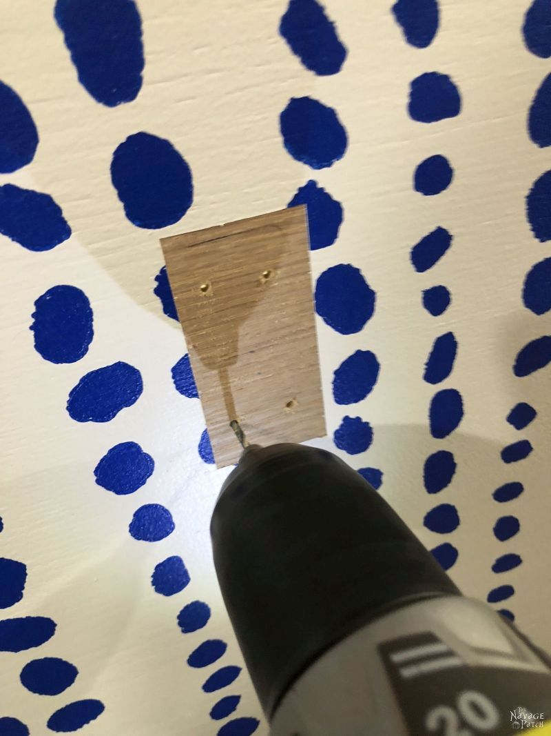 drill making holes in a piece of plywood