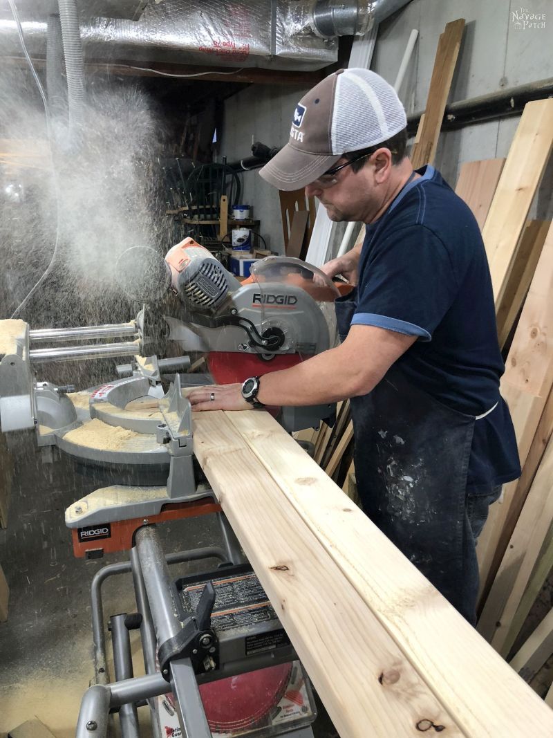 man cutting wood on a miter saw