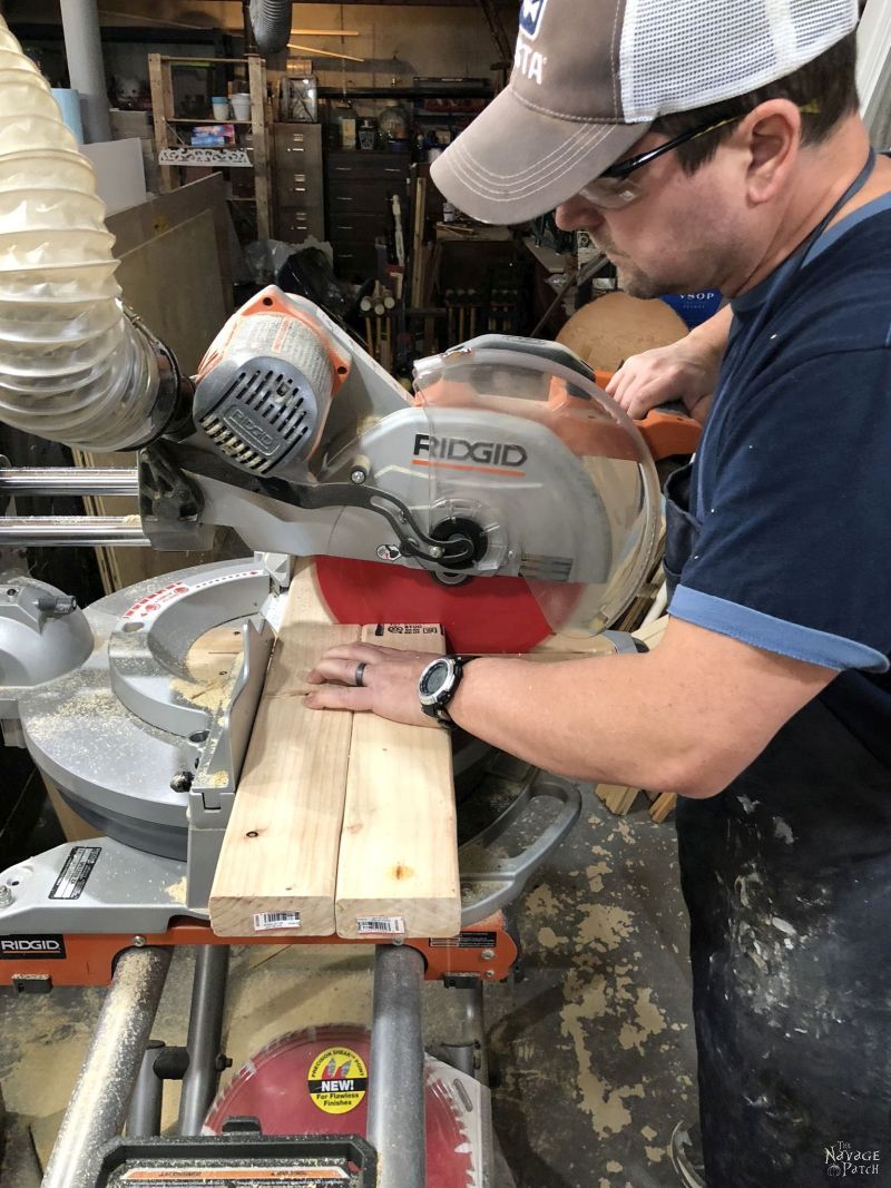 man cutting wood on a miter saw