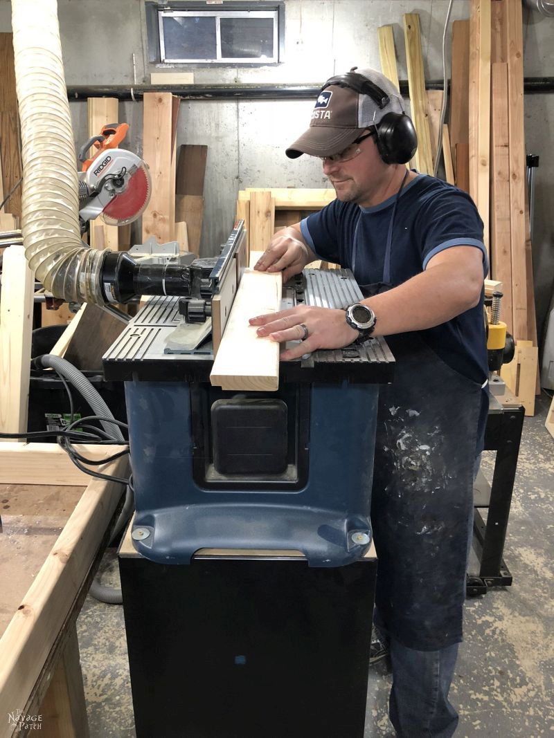 man running a board through a router