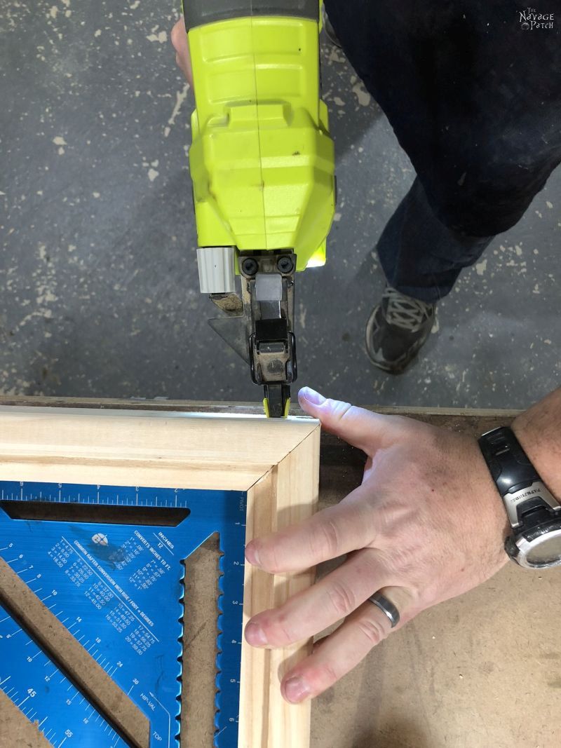 man braid nailing a frame