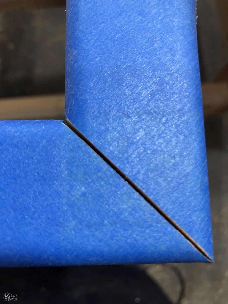 blue tape on the corner of a frame