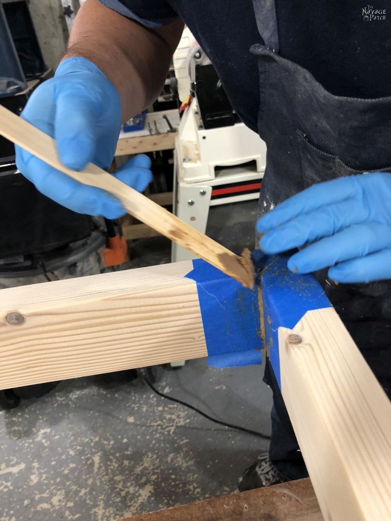 applying wood filer to a gap in a wooden frame