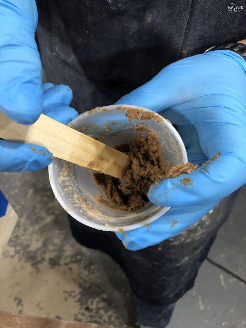 mixing diy wood filler in a cup