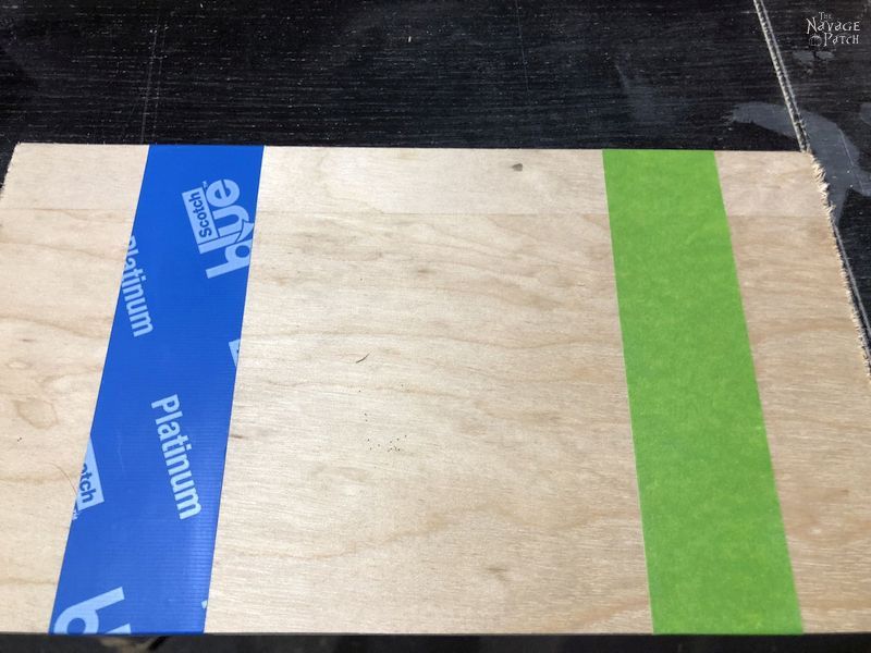 blue and green painter's tape on plywood