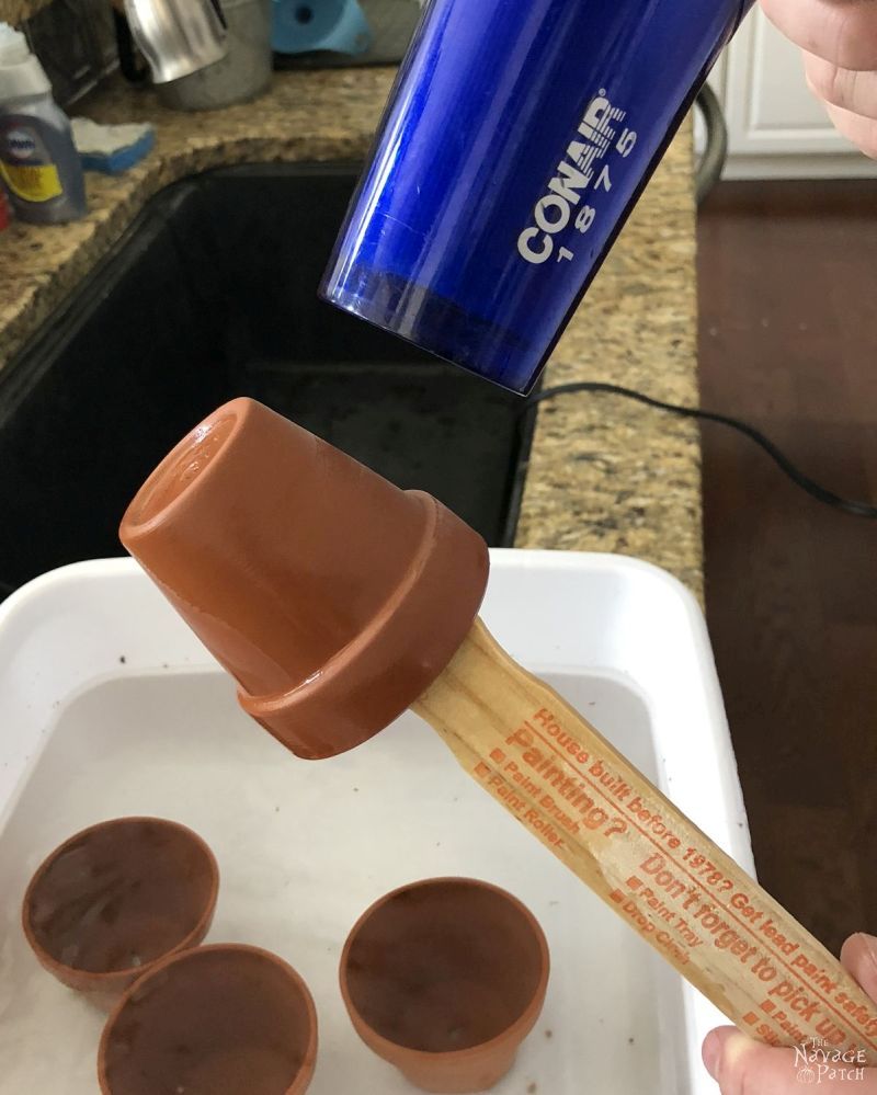 drying a terra cotta pot with a hair dryer