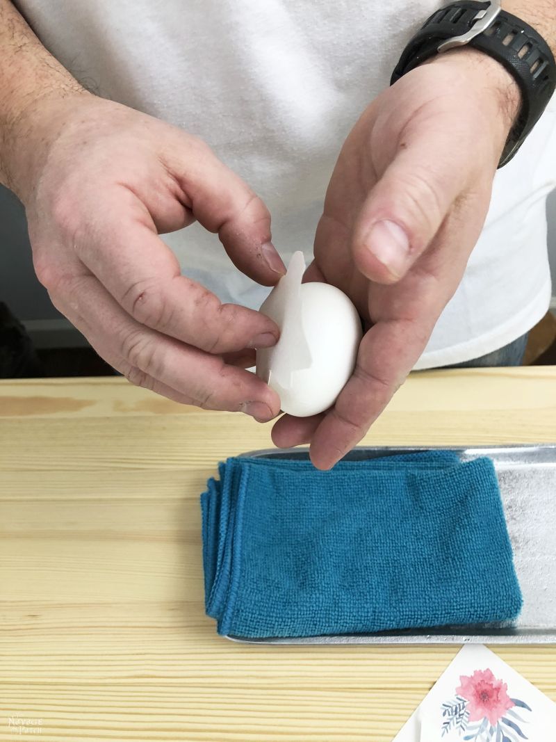 Man placing the watercolor tattoo on the egg