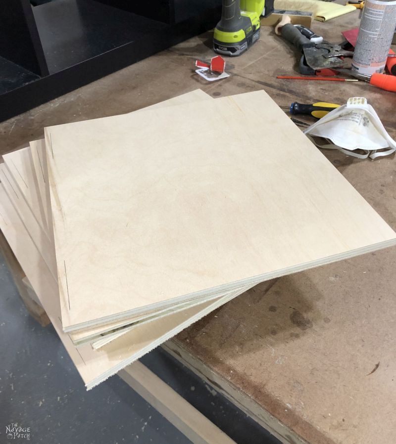 8 square plywood boards on a table