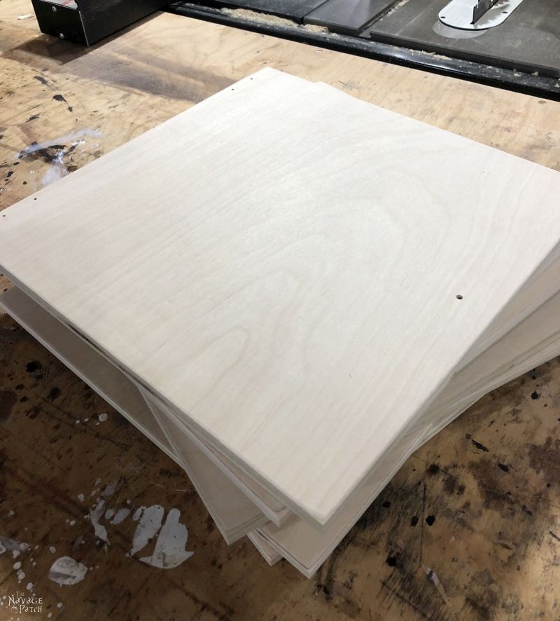 8 square plywood boards on a table