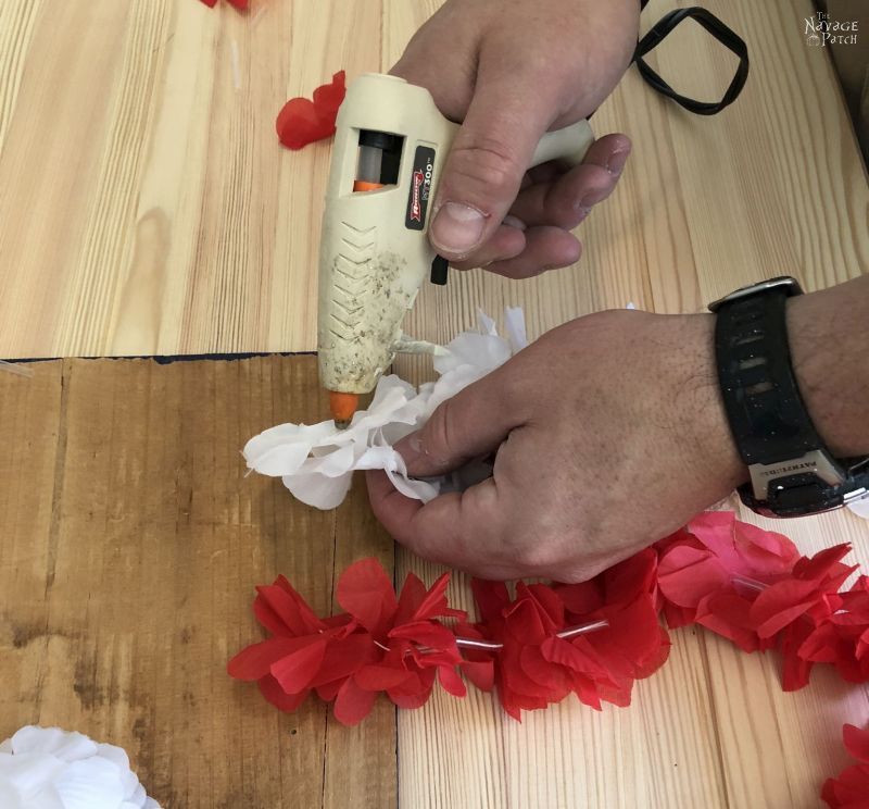 hot gluing a lei to a board