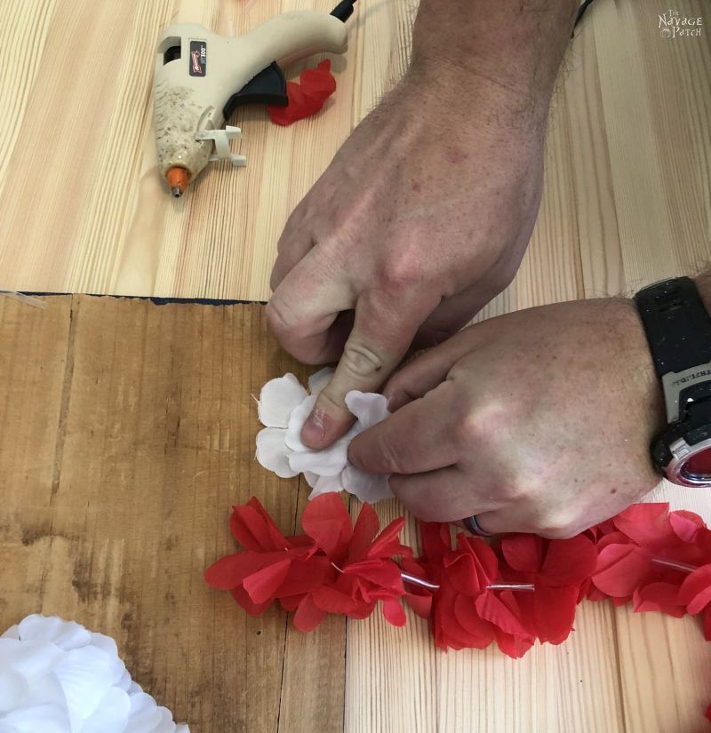 hot gluing a lei to a board