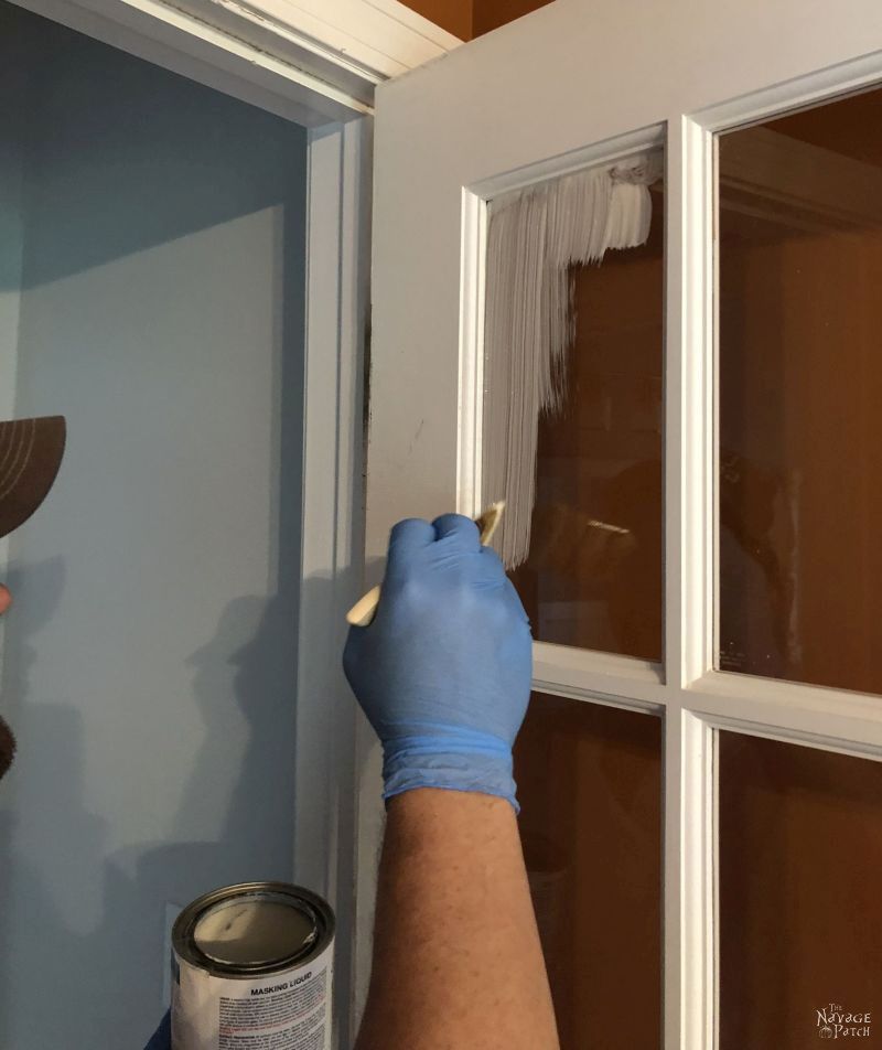 applying masking liquid to a french door to be painted