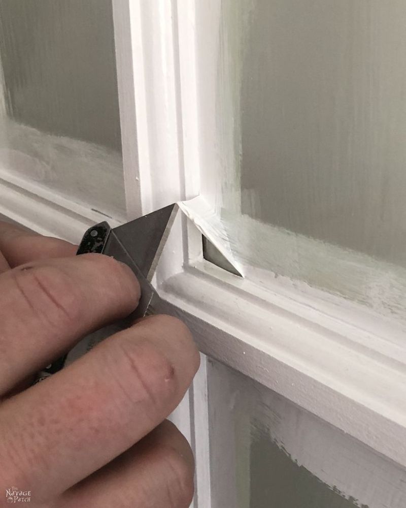 peeling the mask from a french door pane